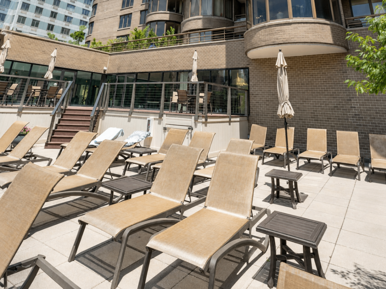 Sun deck with lounge chairs at The Corinthian pool