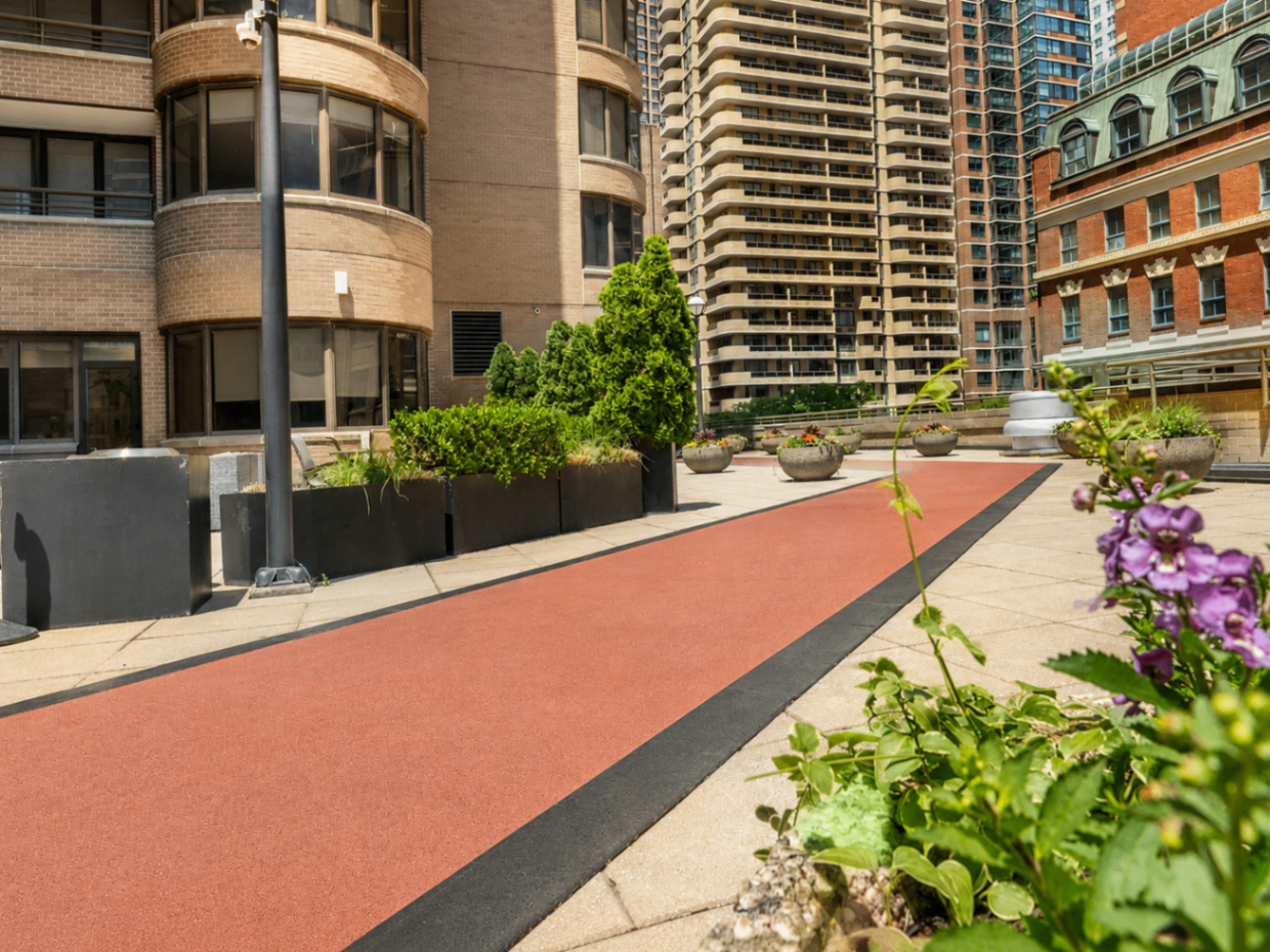 Outdoor running track and landscaped terrace at The Corinthian